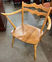 An Ercol Blonde elm and beech 493 model elbow chair