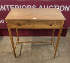 A Danish style walnut single drawer side table