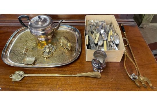 A collection of brass items including a shoe horn, lion's head door knocker, pig figure, mouse, coal