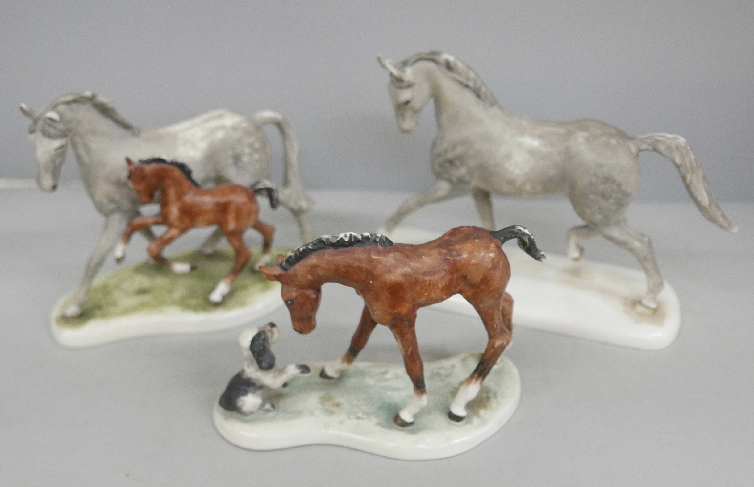 A set of three Goebel horse figures, one with a dog