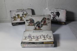 Four assorted Warhammer model kits to include Orruk Brutes, Daemon Prince, Daemonettes, Skaven Storm