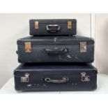 Three vintage Globetrotter vulcanised fibre suitcases in navy blue.