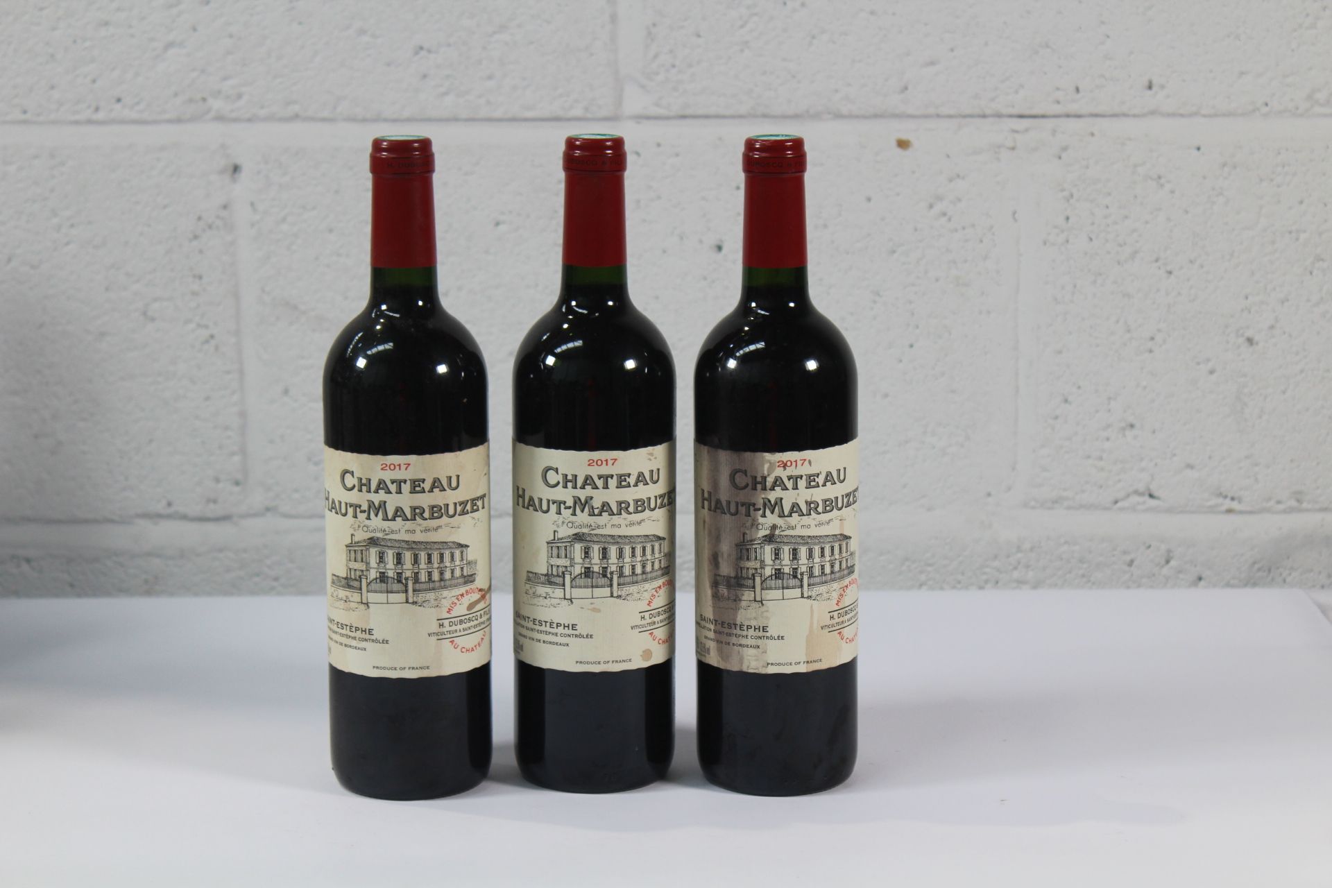 Three Chateau Haut - Marbuzet 2017 Red Wines 3 x 750ml Labels Distressed.