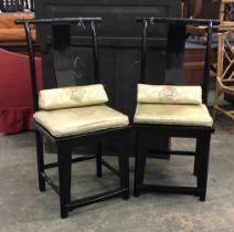 A pair of Chinese black lacquered chairs