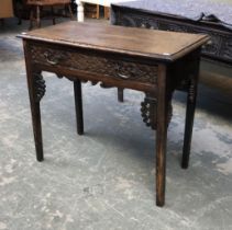 An oak side table, later carved single drawer and applied spandrils, on square tapered legs,