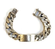 An extremely heavy curb link bracelet, textured links, hallmarked DJ, London, 1976, 28cm long