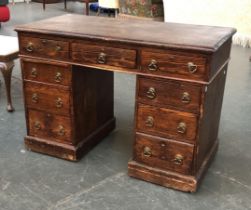 A stained pine pedestal desk, traditional arrangement of nine drawers, 111x56x77cmH