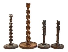 Two oak barleytwist candlesticks; and a further pair of candlesticks, 40cmH, 30cmH and the pair