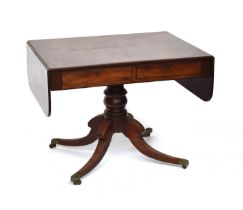 A William IV mahogany sofa table, on a turned column and four swept legs with acanthus caps and