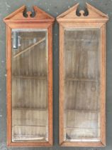 A pair of pier mirrors with broken pediment and bevelled plate, each 94x34cm