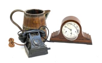 A vintage rotary dial telephone; a T. Wickenham mantel clock; and a large coopered wooden jug