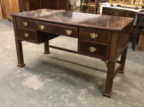 A 20th century kneehole desk, the moulded top over five drawers, on blind fret carved square section