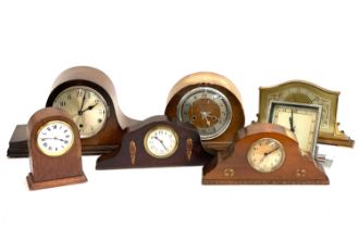 Five early 20th century mantle clocks, one with enamel dial and crossbanded detail, together with