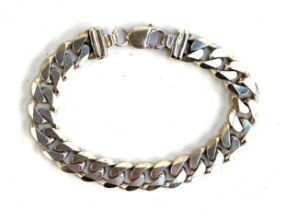 A heavy silver flat curb link bracelet, stamped 925 Italy, 23cmL unclasped, 57.9g