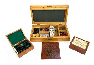 A wooden boxed games compendium containing dominoes, a quantity of antique marbles, solitaire etc;
