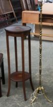 An Edwardian mahogany and strung circular pot stand, the top and undershelf with central patera,