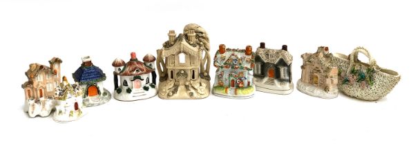 A collection of Staffordshire flatback cottages, some with encrusted detail, the tallest 17.5cmH