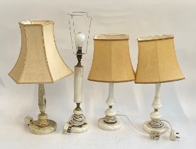 A pair of marble table lamps; together with a further marble table lamp and an onyx table lamp