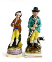 Two 19th century Staffordshire figurines, one a gentleman with a gun and dog, with one other,