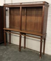 A late 19th century teak bookcase, with adjustable shelves, drawers below, raised on reeded legs,