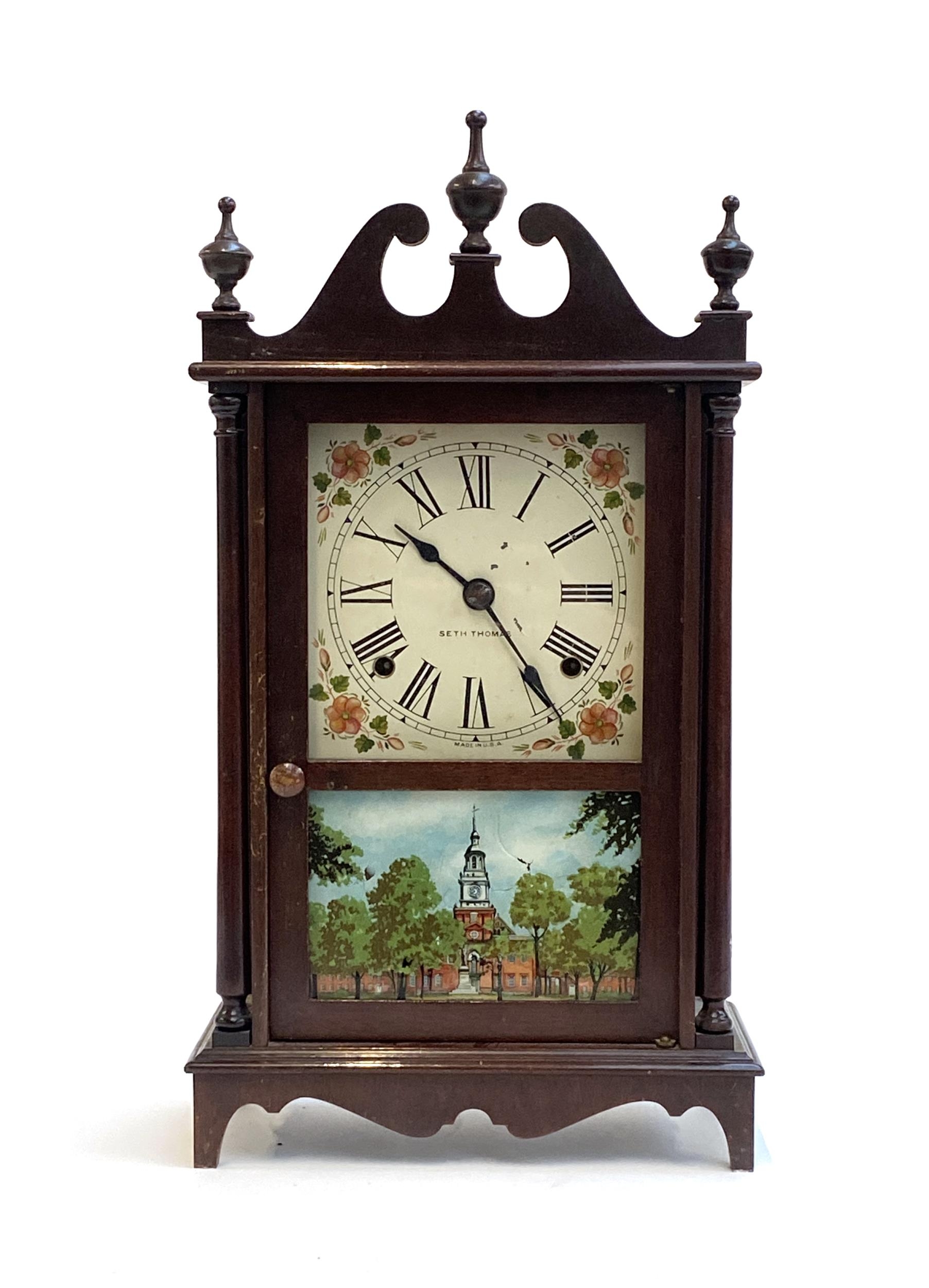 An American mantel clock by Seth Thomas, the door glazed with a print of Independence Hall,