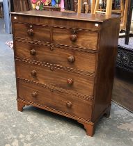 A George III mahogany chest of two short over three graduating drawers, on later bracket feet,