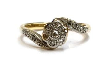 An 18ct gold, platinum and diamond ring of floral form (one diamond missing), size J 1/2, 2.7g