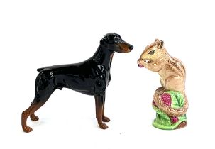 A Beswick figure of a Doberman, 13.5cmH; Together with a Crown Staffordshire figure of a squirrel