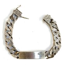 A heavy curb link bracelet with textured links, the tag engraved 'Doug', hallmarked for R Co.,