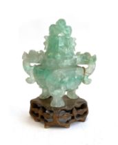 A Chinese carved fluorite censer (af), the lid in the form of a dragon, on a carved wooden base,
