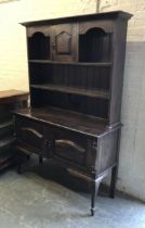 An early 20th century oak dresser with cupboards below, 130x48x191cmH