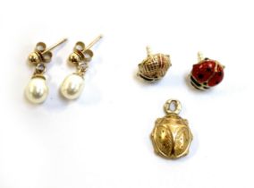 A pair of small 9ct gold and pearl drop stud earrings; together with a pair of 9ct gold ladybird