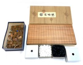 A Chinese Go board game with counters; together with bamboo mahjong pieces