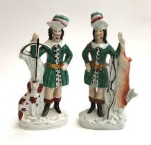 A pair of Staffordshire flatback figurines, 19th century, depicting hunter with spaniel and