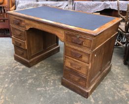 An oak pedestal desk, with the traditional arrangement of drawers, 138x76x78cmH