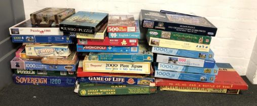 A large quantity of board games and puzzles to include Family Guy Monopoly, Buckaroo, Buccaneer,