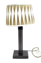 A Valsan table lamp, with pleated shade, on a black patinated metal four column support and square