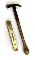 A small antique brass and wood spirit level, 15.5cmL; together with a small claw hammer with