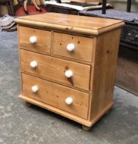 A pine chest of two short over two long drawers, white ceramic knobs, 74x45x80cmH