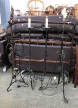 A pair of wrought iron standard lamps, 130cmH; a further wrought iron standard lamp; and a wrought