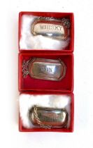 Three boxed silver decanter labels by Francis Howard Ltd, Sheffield 1986, Whisky, Sherry, and Gin