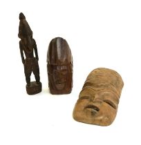 Three carved wood figures, two from Papua New Guinea, the tallest 25cmH