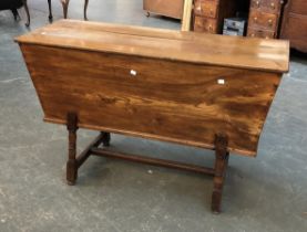 An 18th century elm dough bin, on turned legs joined by moulded H stretcher, 120x48x72cmH