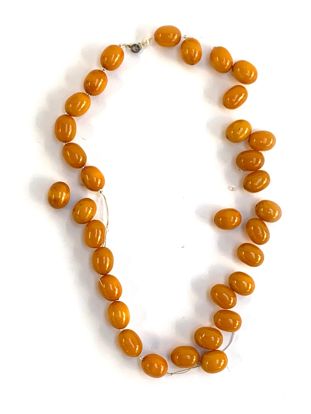 A bakelite type bead necklace in need of restringing, the beads each approx. 1.9cm, gross weight 116