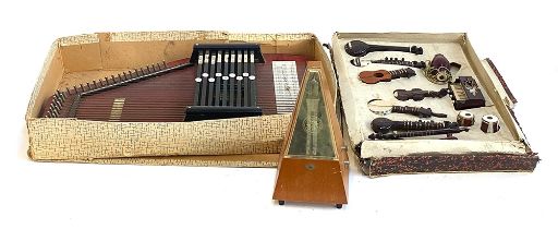 A nine chord autoharp; a boxed collection of miniature model musical instruments and a metronome