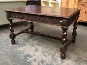 An early 20th century heavy oak dining table, carved frieze on barley twist supports, turned and
