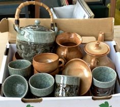 A Japanese turquoise glazed teapot with bamboo handle and 10 matching cups, together with a