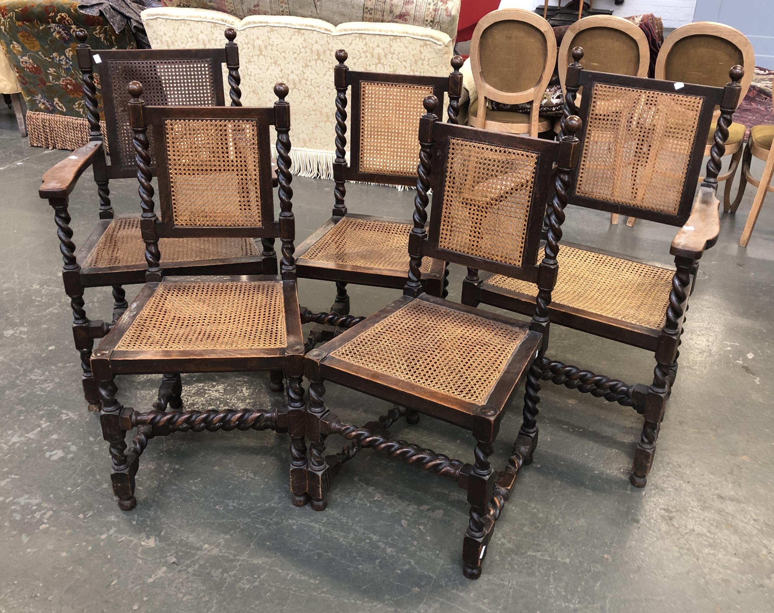 A set of five oak and caned dining chairs, two carvers, with barleytwist supports