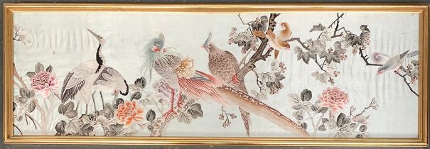 An Oriental silk panel depicting birds amongst foliage, 35x112cm