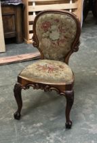 A Victorian carved oak occasional chair, with grospoint back and seat, cabochon capped cabriole legs